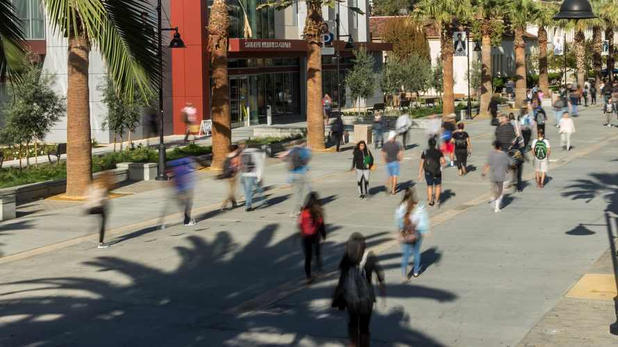 Action shot of students walking on the paseo at SJSU
