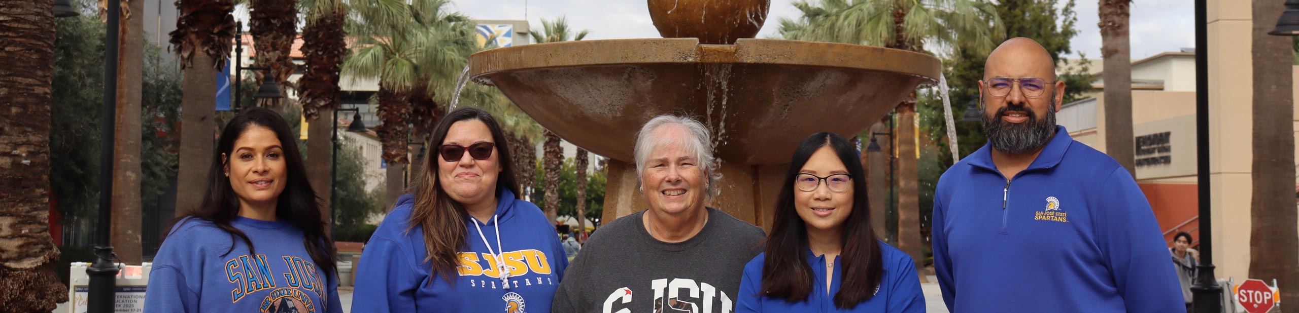 Employees posing for a photo in front of the SJSU fountain